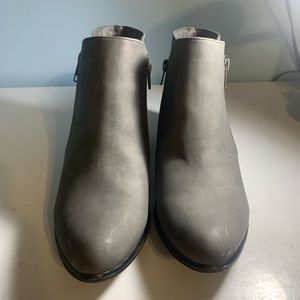 Gray ankle boots with zippers on both sides.